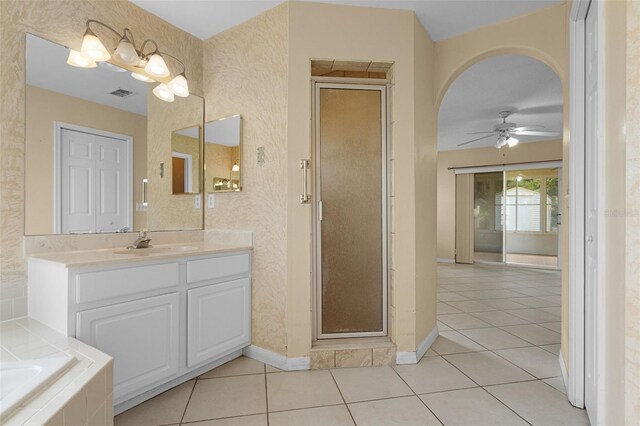 2888 Middleton Cir, Kissimmee, FL 34743 - bathroom featuring vanity, ceiling fan, a stall shower, baseboards, and tile patterned flooring