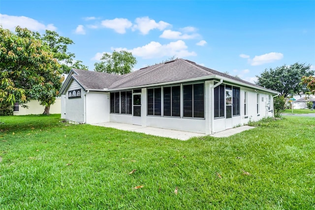 2888 Middleton Cir, Kissimmee, FL 34743 - rear view of property with a sunroom, a lawn, roof with shingles, and stucco siding