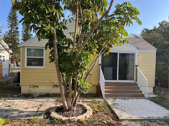 1834 28th Ave N, Saint Petersburg, FL 33713 - rear view of house with entry steps, a shingled roof, and a patio