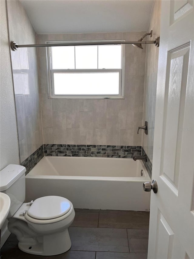 1834 28th Ave N, Saint Petersburg, FL 33713 - full bathroom featuring toilet, shower / bath combination, tile patterned floors, and healthy amount of natural light