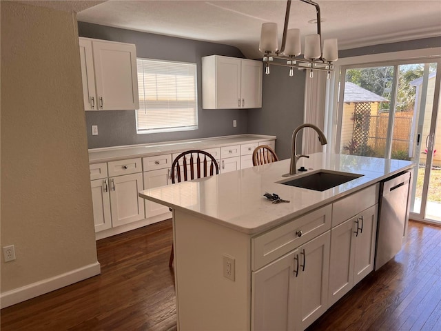 1834 28th Ave N, Saint Petersburg, FL 33713 - kitchen with a sink, dishwasher, dark wood-style flooring, white cabinets, and an island with sink