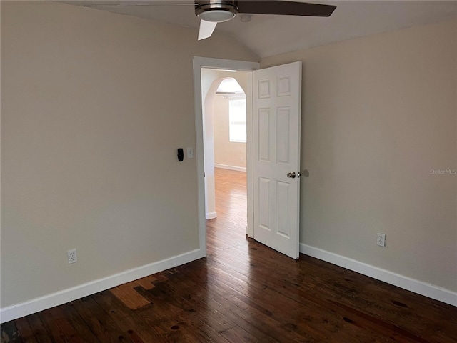 1834 28th Ave N, Saint Petersburg, FL 33713 - empty room with ceiling fan, baseboards, dark wood-style floors, arched walkways, and vaulted ceiling