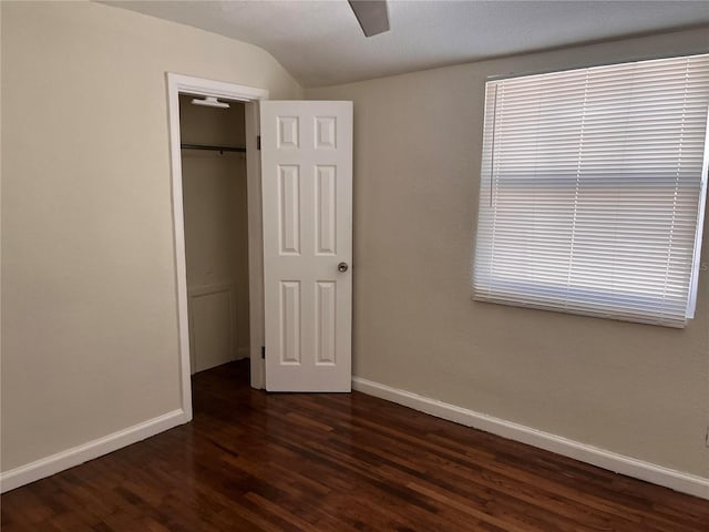 1834 28th Ave N, Saint Petersburg, FL 33713 - unfurnished bedroom featuring dark wood-style floors, baseboards, vaulted ceiling, a closet, and a ceiling fan