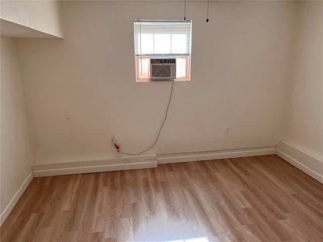 1834 28th Ave N, Saint Petersburg, FL 33713 - spare room featuring light wood finished floors, baseboards, and cooling unit