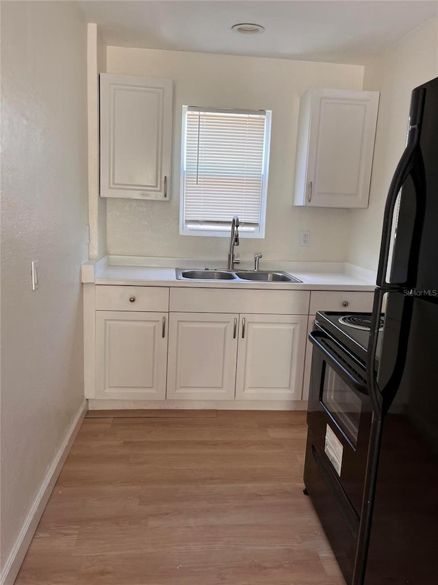 1834 28th Ave N, Saint Petersburg, FL 33713 - kitchen with black appliances, a sink, white cabinets, and light countertops