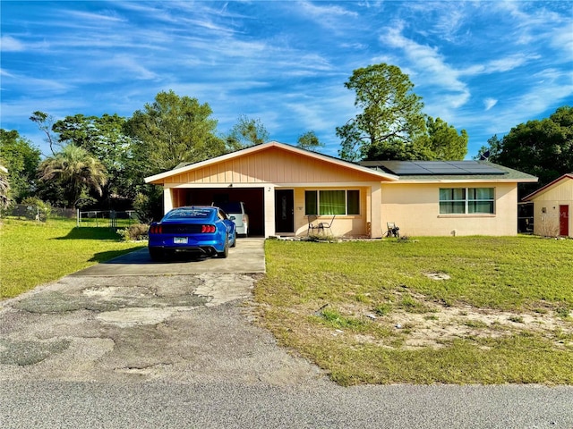 2 Clear Pl, Ocala, FL 34472 - single story home with driveway, roof mounted solar panels, an attached garage, and concrete block siding