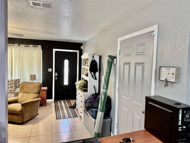 2 Clear Pl, Ocala, FL 34472 - foyer featuring a textured wall, a textured ceiling, and light tile patterned floors
