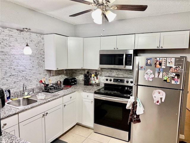 2 Clear Pl, Ocala, FL 34472 - kitchen featuring stainless steel appliances, a sink, white cabinetry, tasteful backsplash, and a textured ceiling