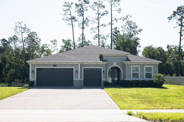 5161 Kingwell Cir, Oviedo, FL 32765 - view of front of home with a garage, decorative driveway, a front lawn, and stucco siding