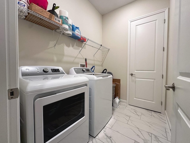 5161 Kingwell Cir, Oviedo, FL 32765 - laundry room featuring washer and dryer and light marble finish flooring