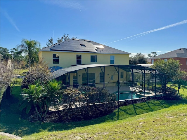 8520 La Isla Dr, Kissimmee, FL 34747 - back of property featuring solar panels, an outdoor pool, a lawn, a patio area, and a lanai