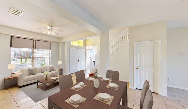 8520 La Isla Dr, Kissimmee, FL 34747 - dining space with stairway, a ceiling fan, light tile patterned floors, and baseboards