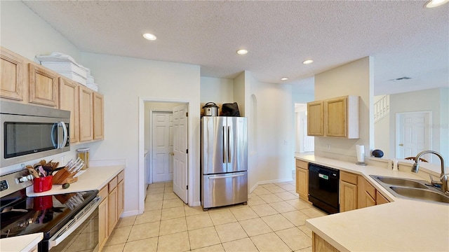 8520 La Isla Dr, Kissimmee, FL 34747 - kitchen featuring appliances with stainless steel finishes, a sink, light brown cabinets, a peninsula, and recessed lighting