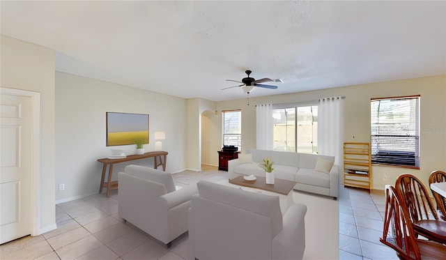 8520 La Isla Dr, Kissimmee, FL 34747 - living room featuring light tile patterned flooring, healthy amount of natural light, and a ceiling fan