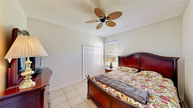 8520 La Isla Dr, Kissimmee, FL 34747 - bedroom with a textured ceiling, a closet, light tile patterned flooring, a ceiling fan, and baseboards