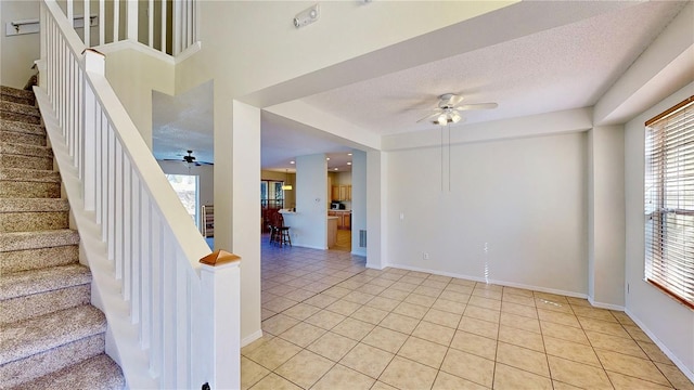 8520 La Isla Dr, Kissimmee, FL 34747 - staircase with a ceiling fan, healthy amount of natural light, tile patterned floors, and a textured ceiling