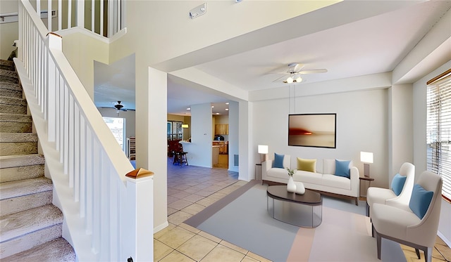 8520 La Isla Dr, Kissimmee, FL 34747 - living area featuring ceiling fan, light tile patterned floors, and stairs