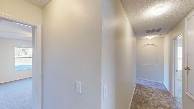 8520 La Isla Dr, Kissimmee, FL 34747 - corridor with a textured ceiling, carpet floors, and baseboards