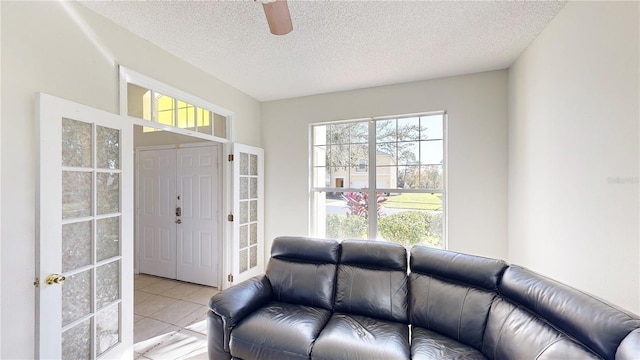 8520 La Isla Dr, Kissimmee, FL 34747 - living area featuring ceiling fan, a textured ceiling, and light tile patterned floors