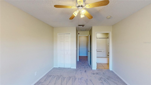 8520 La Isla Dr, Kissimmee, FL 34747 - unfurnished bedroom with a textured ceiling, light colored carpet, a closet, baseboards, and ceiling fan