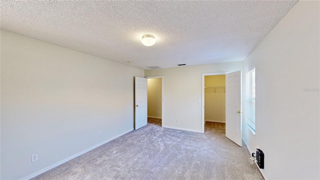 8520 La Isla Dr, Kissimmee, FL 34747 - unfurnished bedroom featuring carpet flooring, baseboards, a spacious closet, a textured ceiling, and a closet