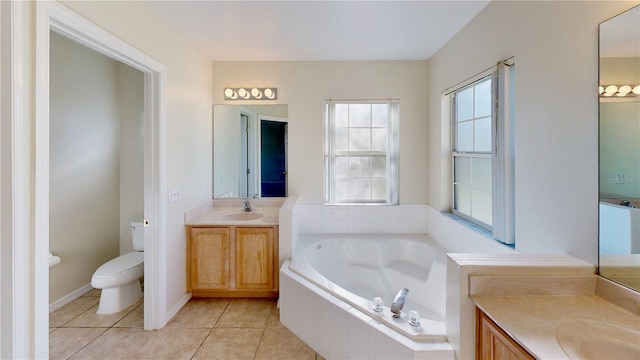 8520 La Isla Dr, Kissimmee, FL 34747 - full bathroom featuring two vanities, a bath, toilet, and tile patterned flooring