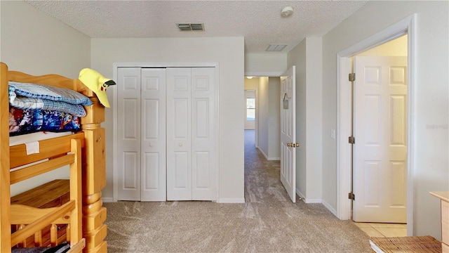 8520 La Isla Dr, Kissimmee, FL 34747 - bedroom with a closet, light carpet, and a textured ceiling