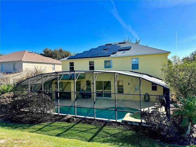 8520 La Isla Dr, Kissimmee, FL 34747 - rear view of house featuring roof mounted solar panels, a patio area, a yard, and stucco siding