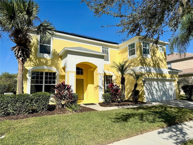 8520 La Isla Dr, Kissimmee, FL 34747 - mediterranean / spanish-style house featuring stucco siding, a garage, a front lawn, and driveway