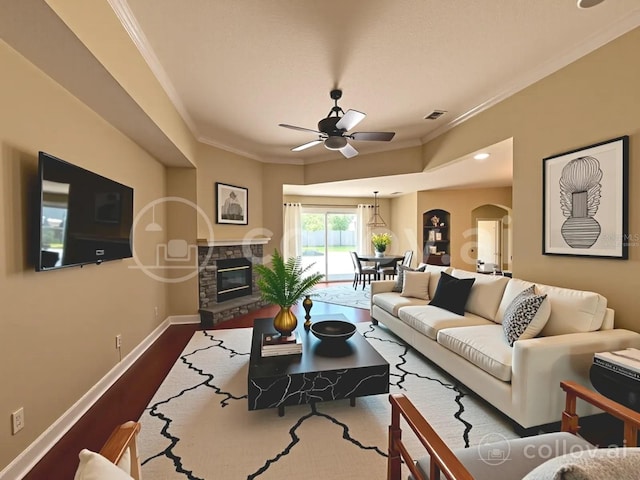 2585 Woodside Ridge Dr, Apopka, FL 32712 - living room with arched walkways, a ceiling fan, ornamental molding, baseboards, and dark wood finished floors
