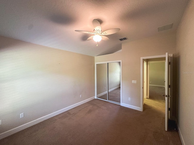 2585 Woodside Ridge Dr, Apopka, FL 32712 - unfurnished bedroom with vaulted ceiling, dark colored carpet, baseboards, a closet, and ceiling fan