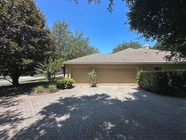 2585 Woodside Ridge Dr, Apopka, FL 32712 - view of home's exterior with an attached garage, decorative driveway, and stucco siding