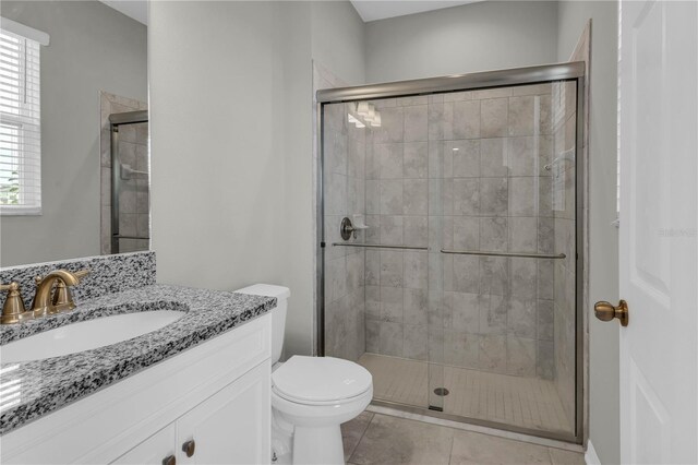 3137 Marine Grass Dr, Wimauma, FL 33598 - full bathroom featuring vanity, toilet, a shower stall, and tile patterned floors