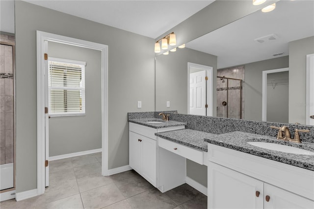 3137 Marine Grass Dr, Wimauma, FL 33598 - bathroom featuring a shower stall, double vanity, baseboards, and a walk in closet