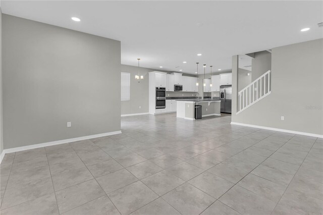 3137 Marine Grass Dr, Wimauma, FL 33598 - unfurnished living room with baseboards, recessed lighting, light tile patterned flooring, and stairs