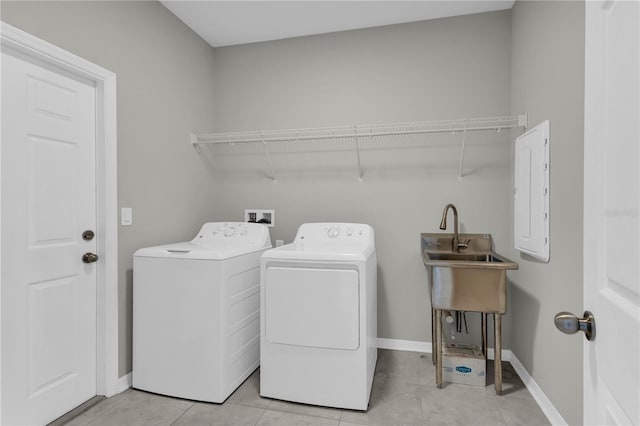3137 Marine Grass Dr, Wimauma, FL 33598 - laundry room featuring washer and dryer, electric panel, baseboards, and light tile patterned floors