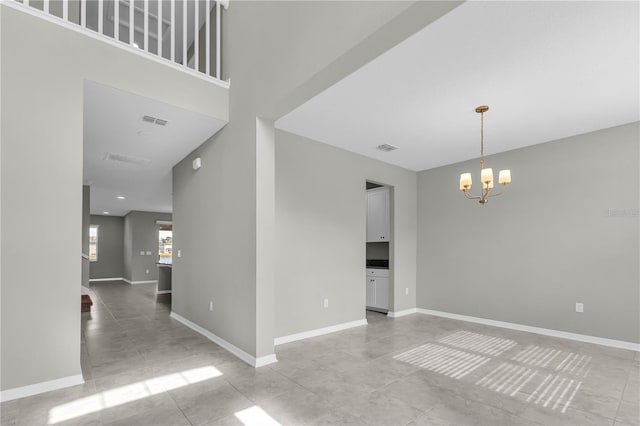 3137 Marine Grass Dr, Wimauma, FL 33598 - spare room with a chandelier, baseboards, and light tile patterned flooring