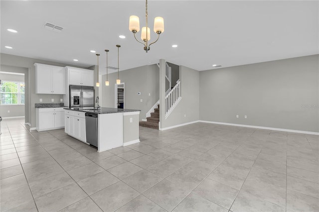 3137 Marine Grass Dr, Wimauma, FL 33598 - kitchen featuring appliances with stainless steel finishes, open floor plan, a kitchen island with sink, light tile patterned floors, and recessed lighting