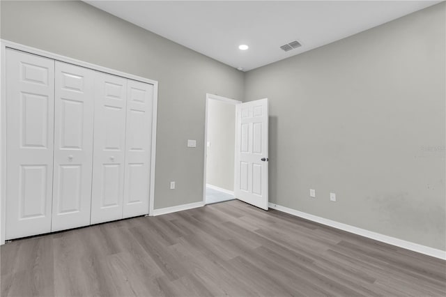3137 Marine Grass Dr, Wimauma, FL 33598 - unfurnished bedroom featuring wood finished floors, baseboards, a closet, and recessed lighting