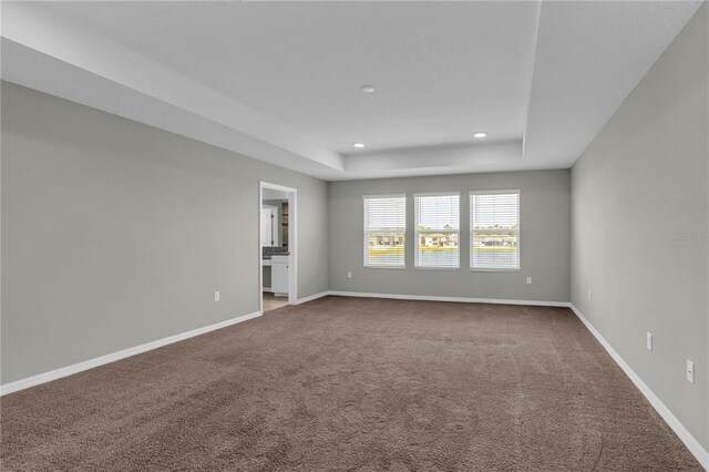 3137 Marine Grass Dr, Wimauma, FL 33598 - carpeted empty room featuring a tray ceiling, recessed lighting, and baseboards