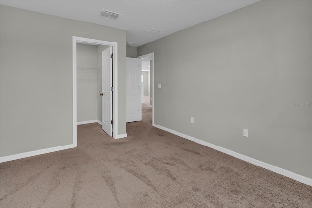 3137 Marine Grass Dr, Wimauma, FL 33598 - unfurnished bedroom featuring carpet, a walk in closet, baseboards, and a closet