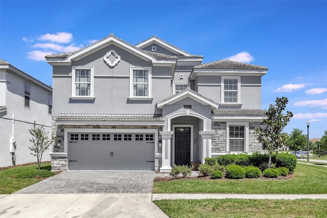 1533 Flange Dr, Davenport, FL 33896 - view of front of house featuring stone siding, driveway, and a tiled roof