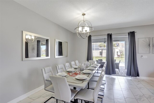 1533 Flange Dr, Davenport, FL 33896 - dining room featuring light marble finish flooring, a chandelier, baseboards, and a textured ceiling