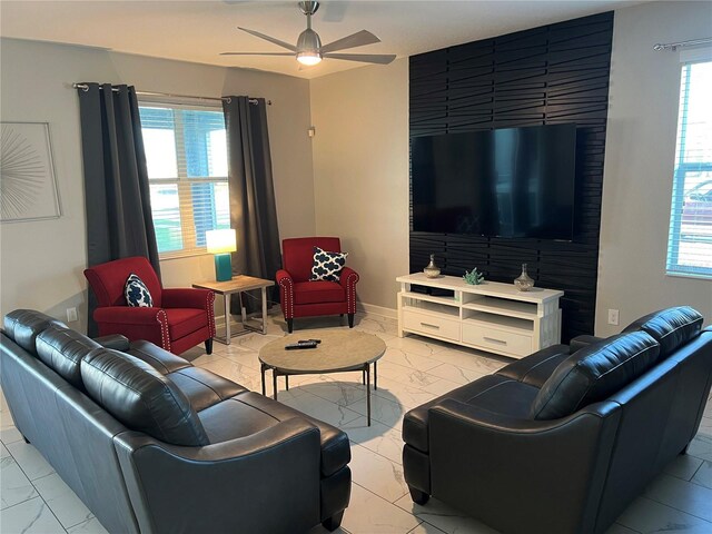 1533 Flange Dr, Davenport, FL 33896 - living area featuring light marble finish flooring, a ceiling fan, and baseboards