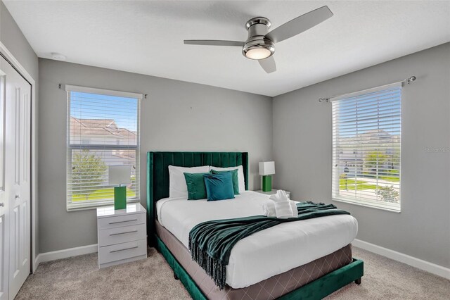 1533 Flange Dr, Davenport, FL 33896 - carpeted bedroom with baseboards, multiple windows, a closet, and ceiling fan