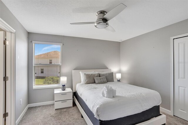 1533 Flange Dr, Davenport, FL 33896 - bedroom with light colored carpet, baseboards, and a ceiling fan