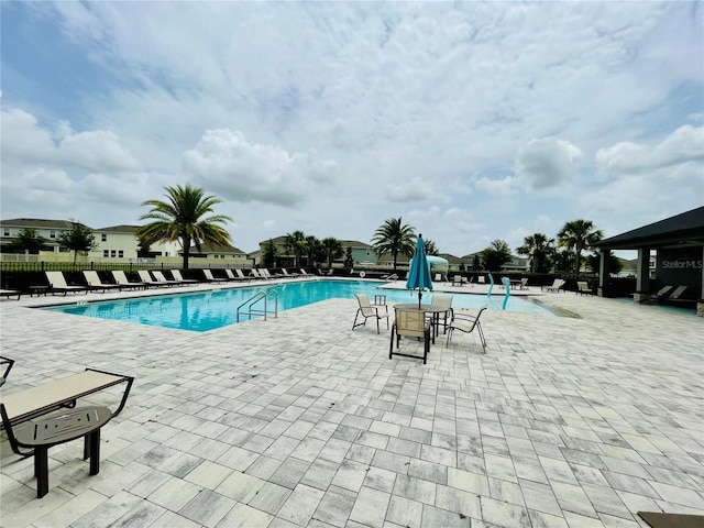 344 Switchgrass Loop, Minneola, FL 34715 - community pool featuring a patio area