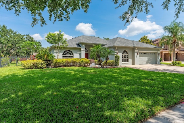 13108 Lakeshore Grove Dr, Winter Garden, FL 34787 - view of front of home featuring a garage, stucco siding, and concrete driveway