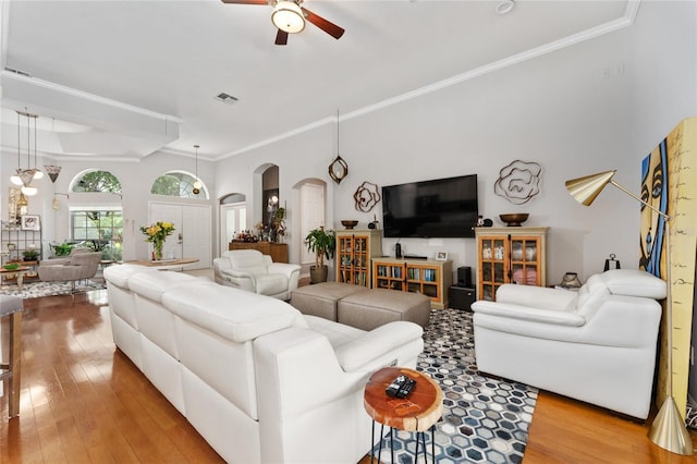 13108 Lakeshore Grove Dr, Winter Garden, FL 34787 - living area with a ceiling fan, arched walkways, wood finished floors, and ornamental molding