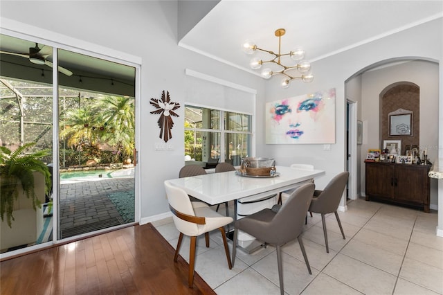 13108 Lakeshore Grove Dr, Winter Garden, FL 34787 - dining room featuring arched walkways, baseboards, crown molding, a chandelier, and ceiling fan